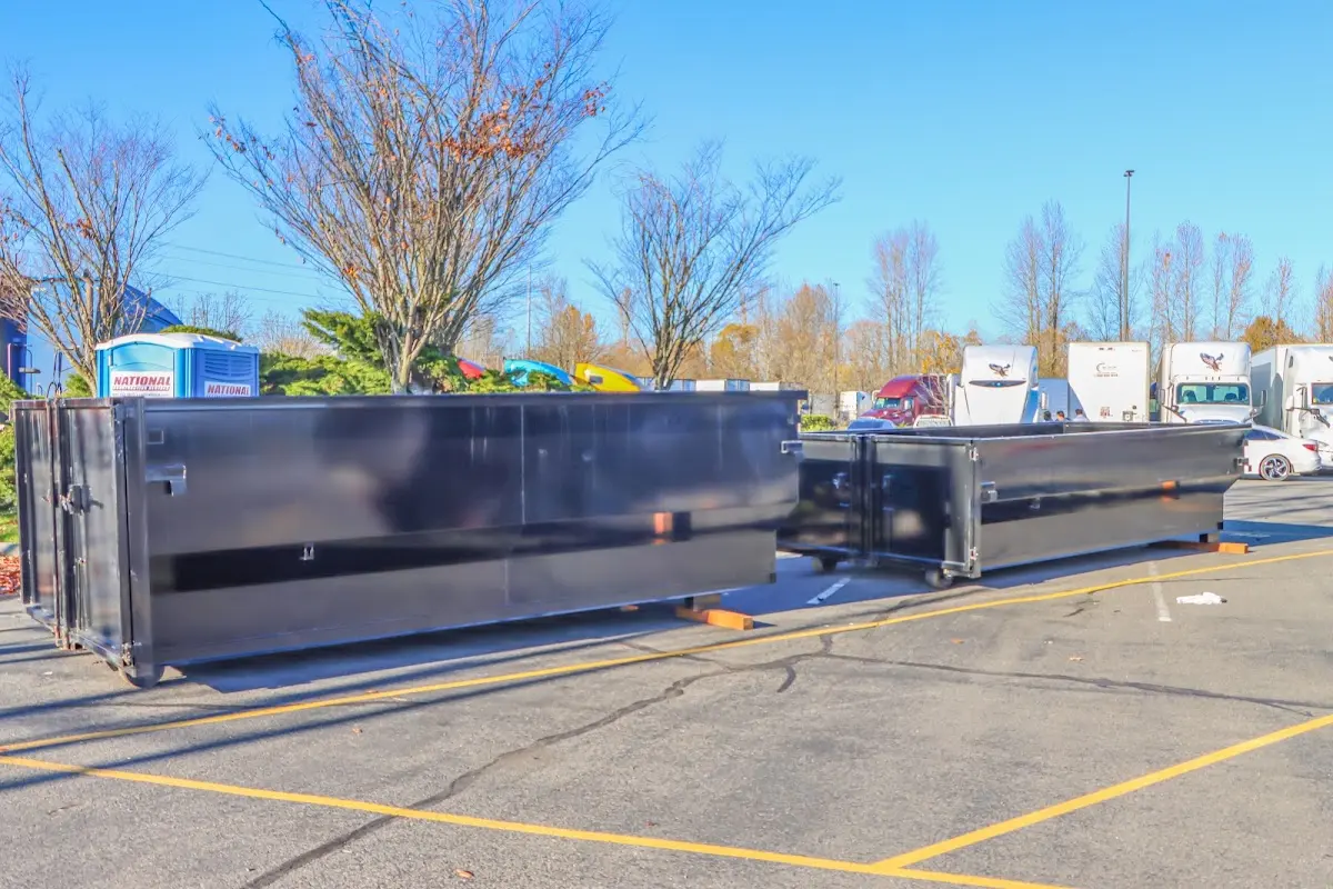 Professional dumpster rental service with roll-off container on residential driveway in Kimberly